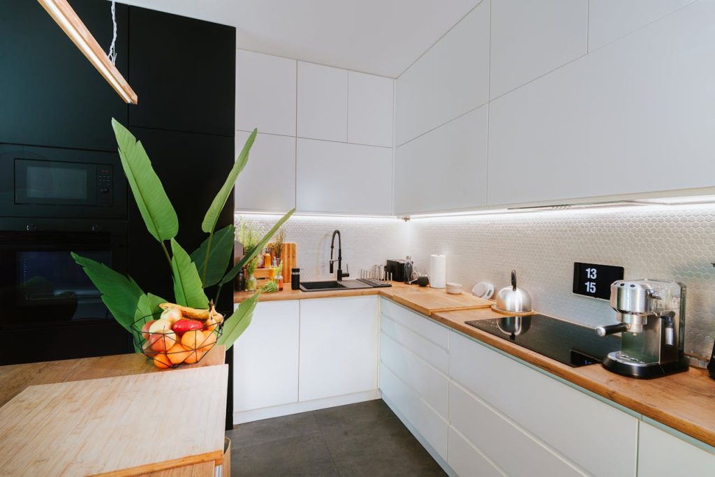 home-living-room-kitchen-interior-27390284 Sleek kitchen featuring smart tech and minimalist design, perfect for modern homes.
